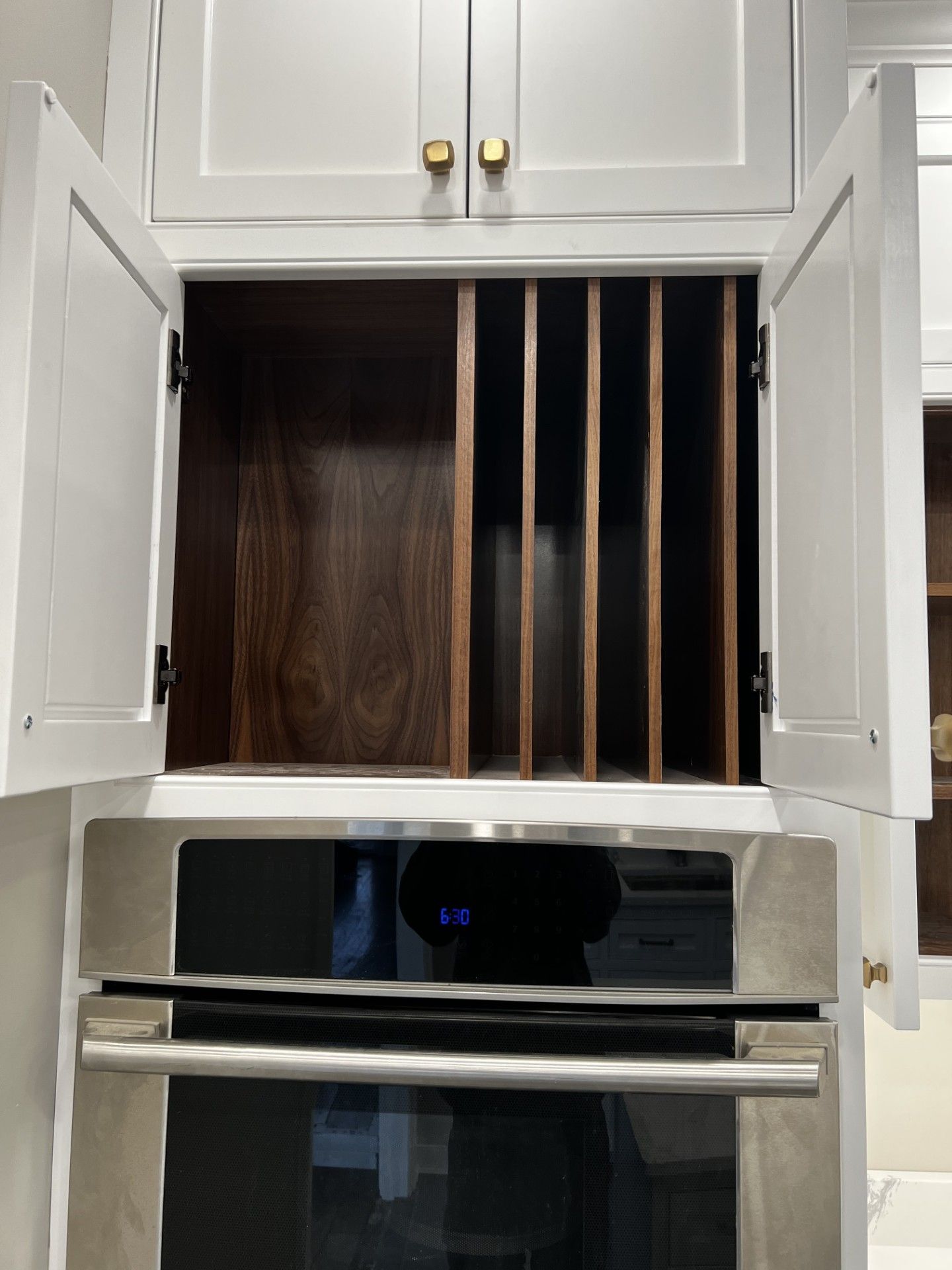 A stainless steel oven in a kitchen with the door open