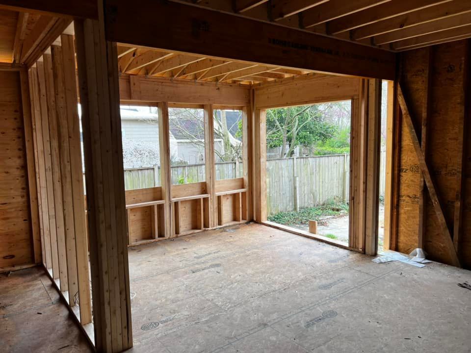 A room in a house under construction with a sliding glass door.