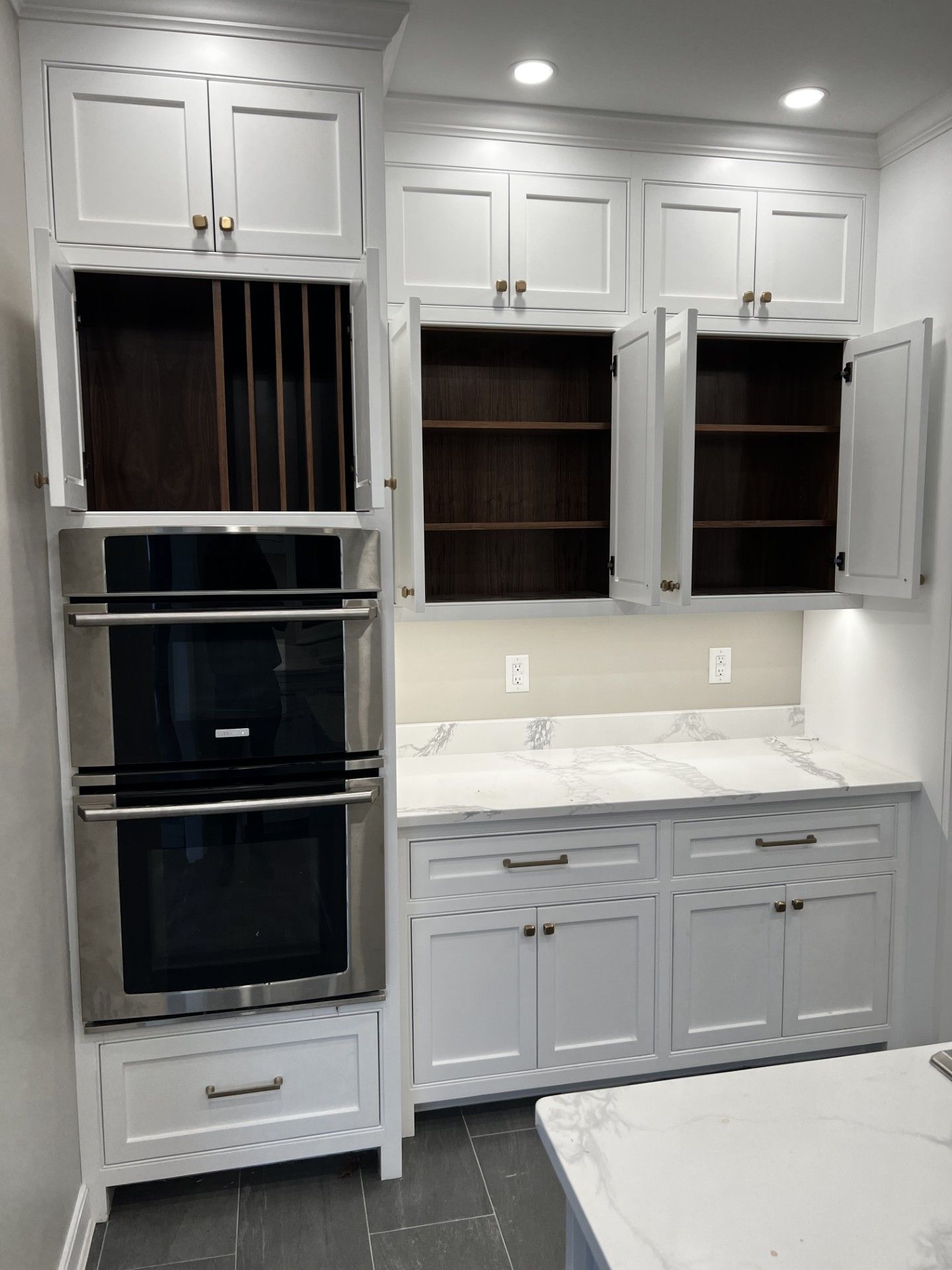 A kitchen with white cabinets and stainless steel appliances.