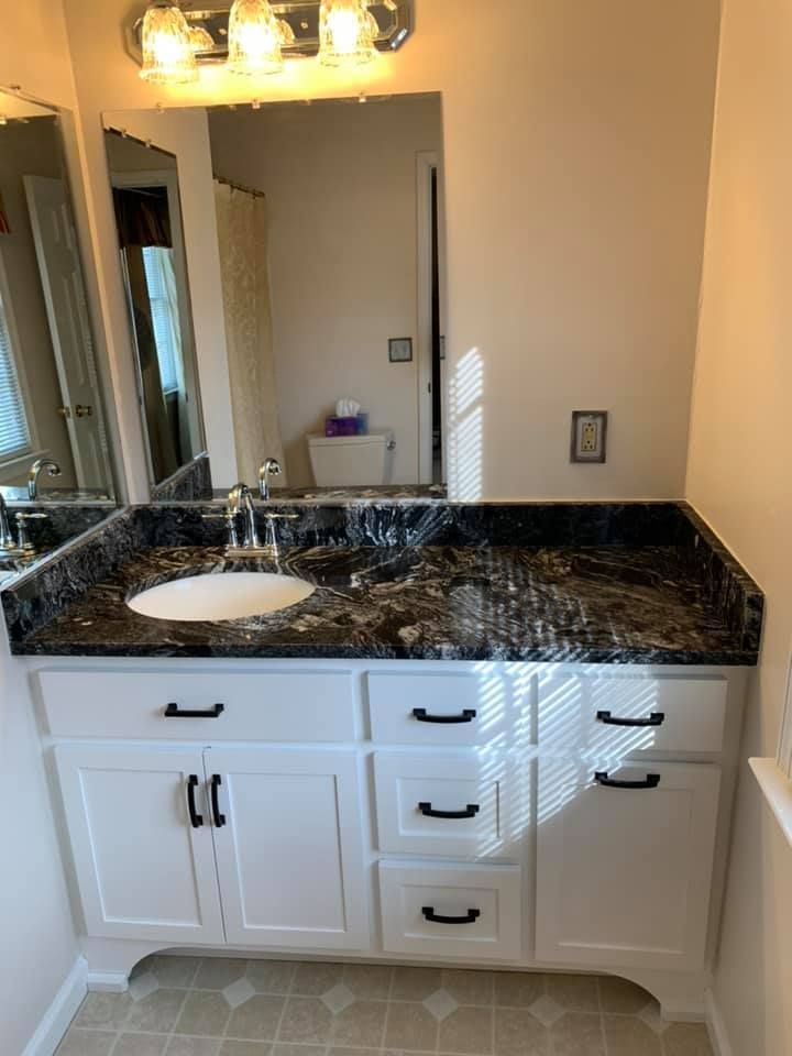 A bathroom vanity with a sink and a mirror.