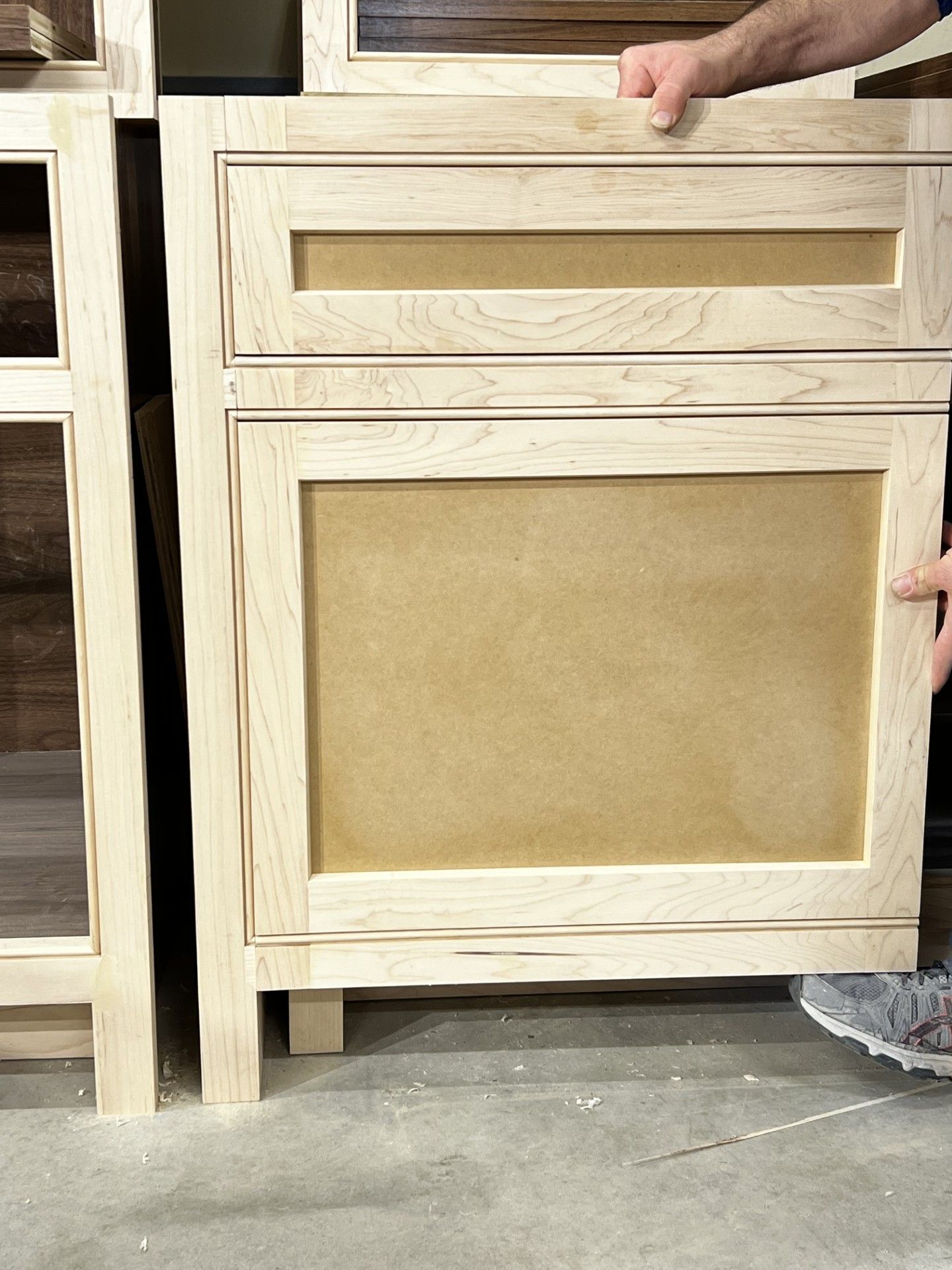 A person is holding a piece of wood in their hands