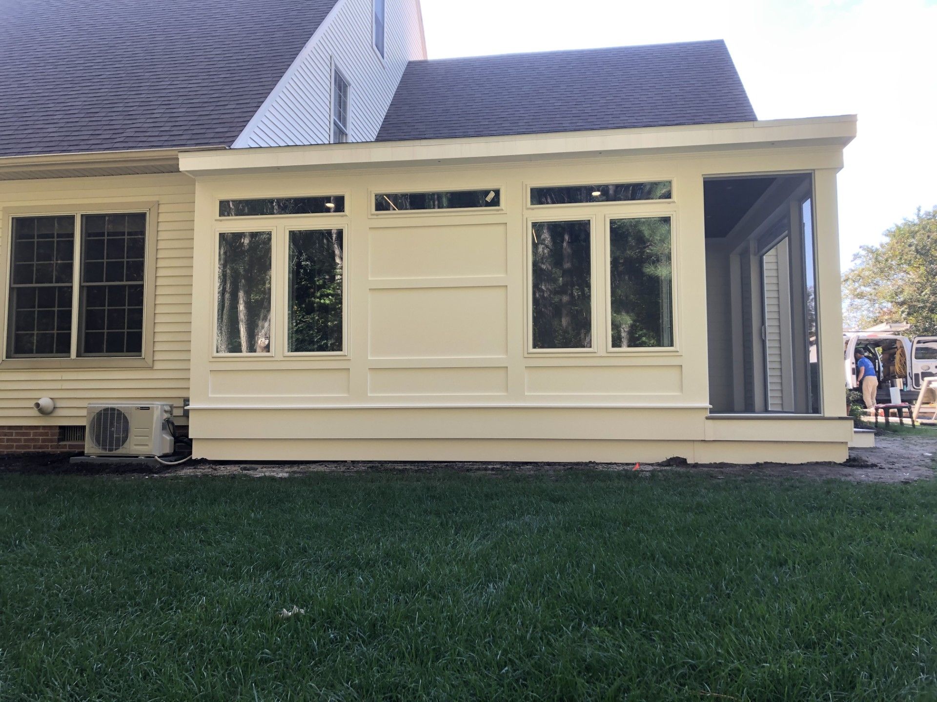 A sun room is being built on the side of a house.