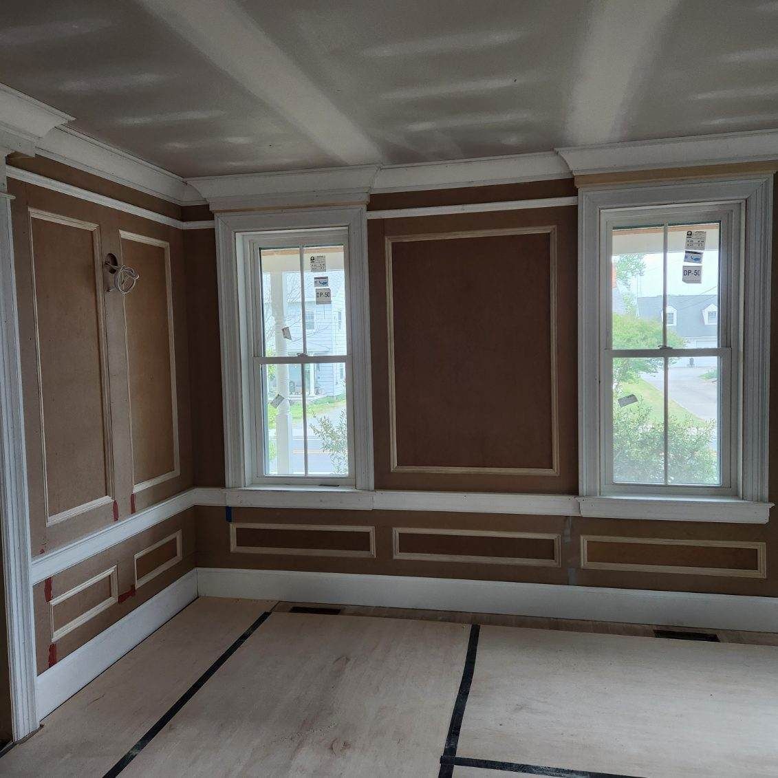 A room with a lot of windows and brown walls