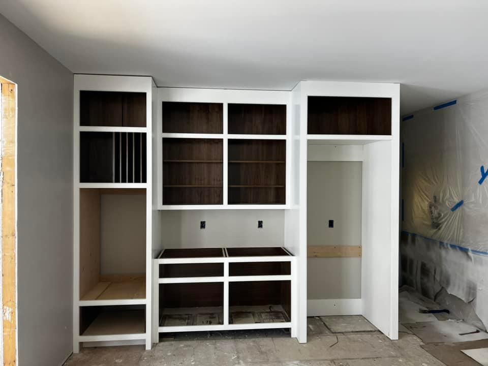 A room with a lot of shelves and drawers in it.