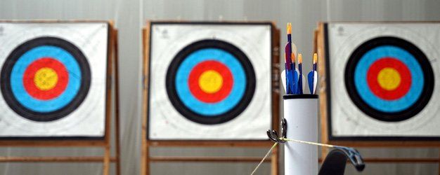 arrows and archery target in the background