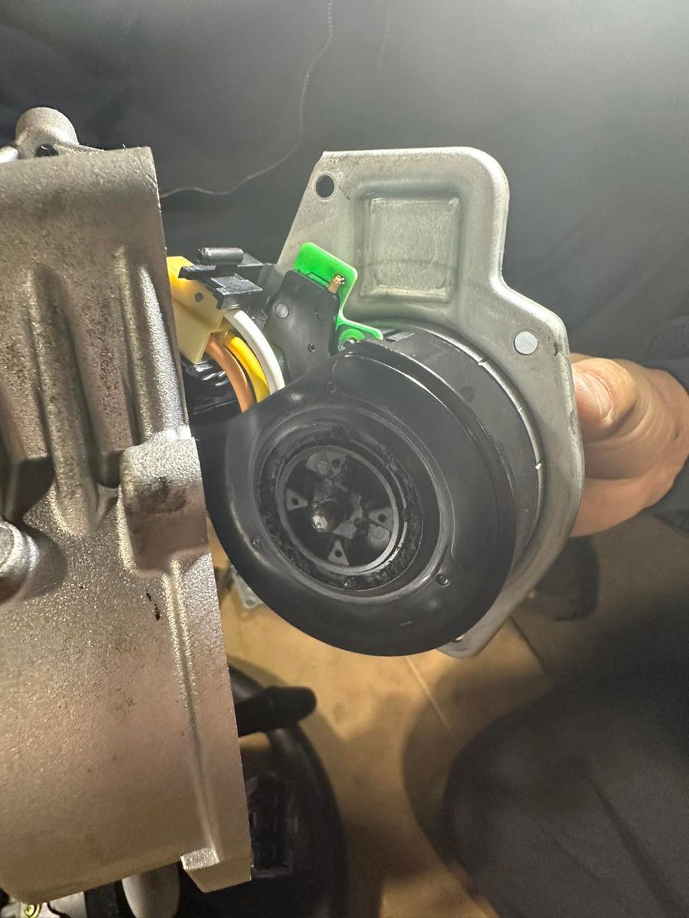 A person is holding a piece of metal in their hand.