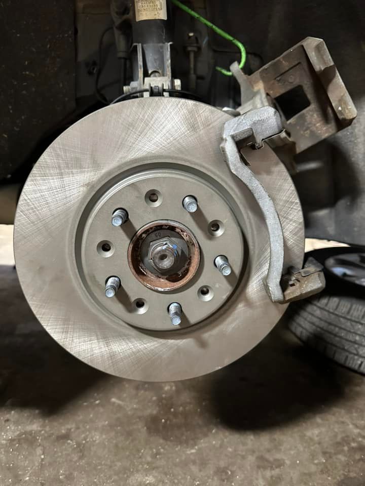 A close up of a brake disc on a car.