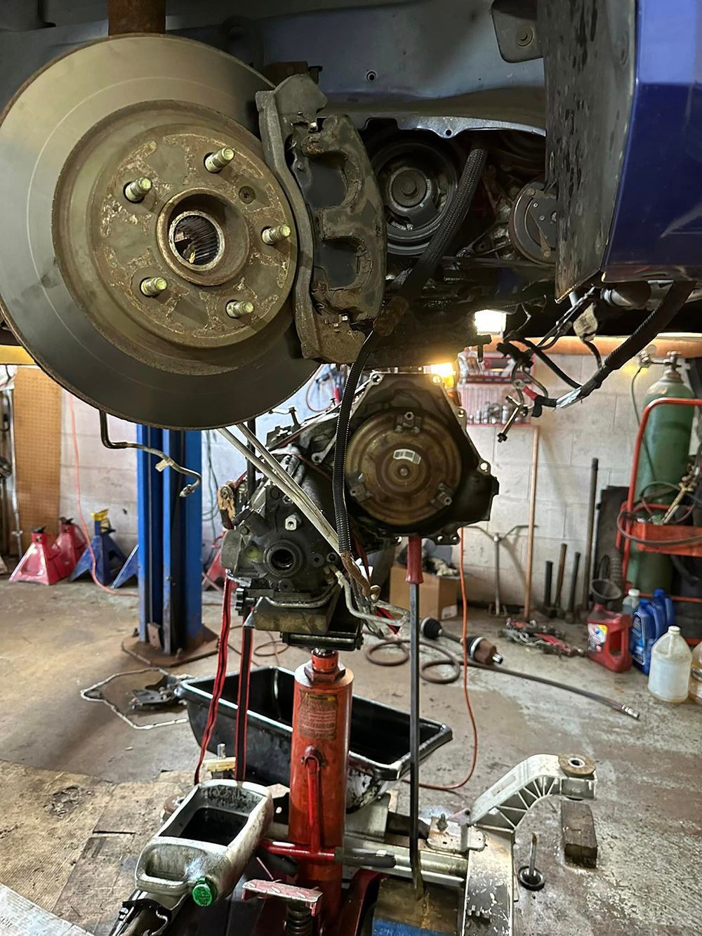 A car engine is being worked on in a garage.