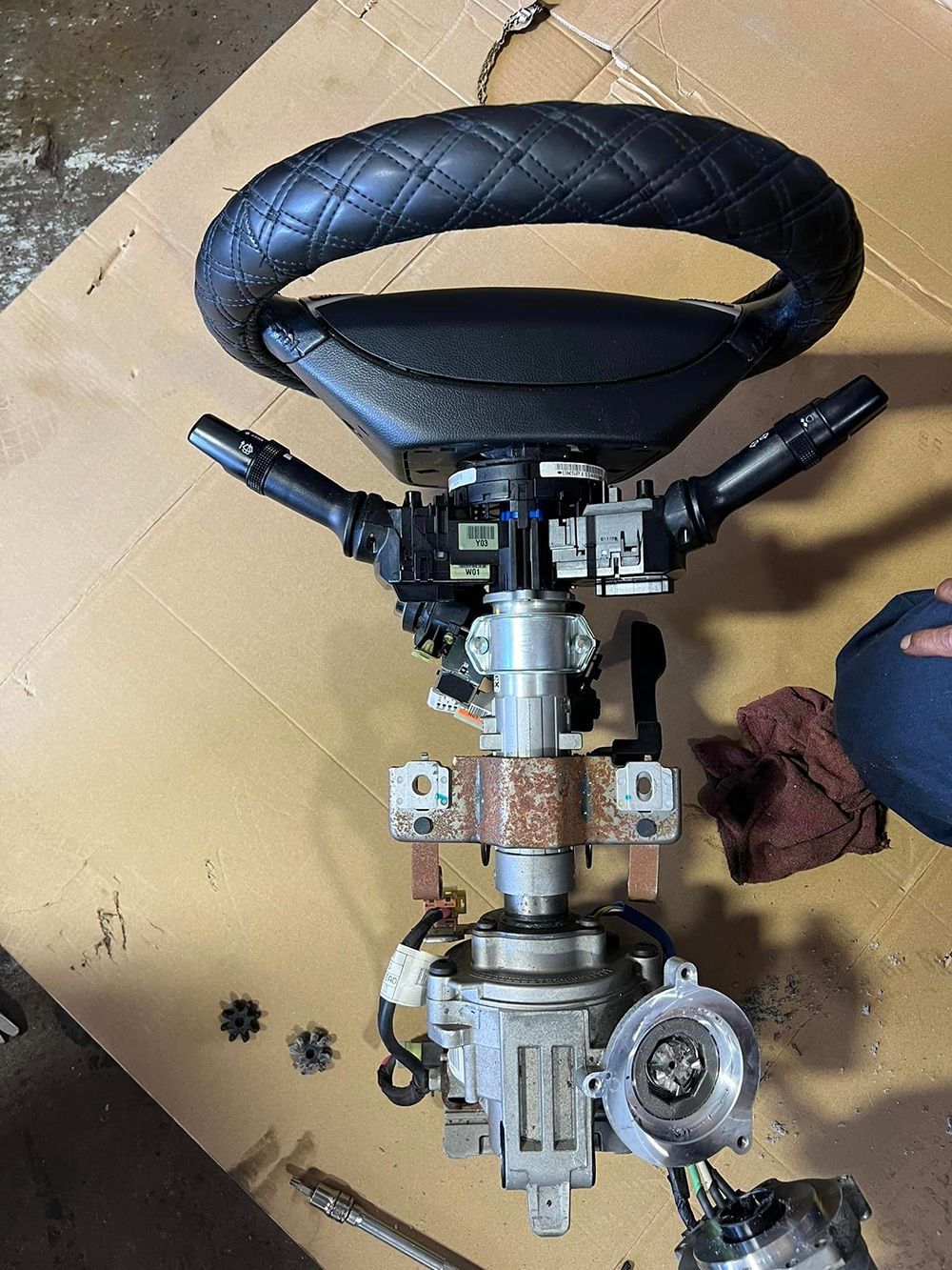 A steering wheel is sitting on top of a cardboard box.