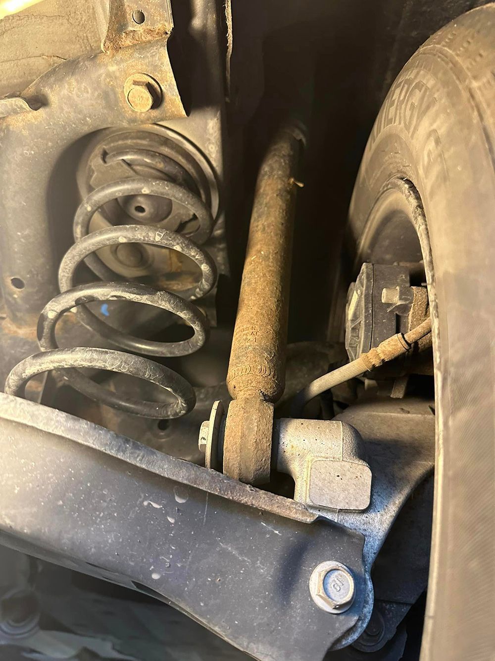 A close up of a shock absorber on a car.