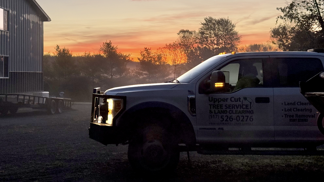Truck parked in front of a building at sunrise, with text on the side.