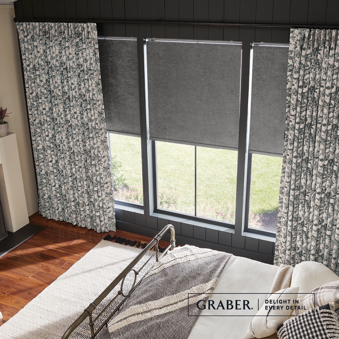 A bedroom with a bed , curtains and a window.