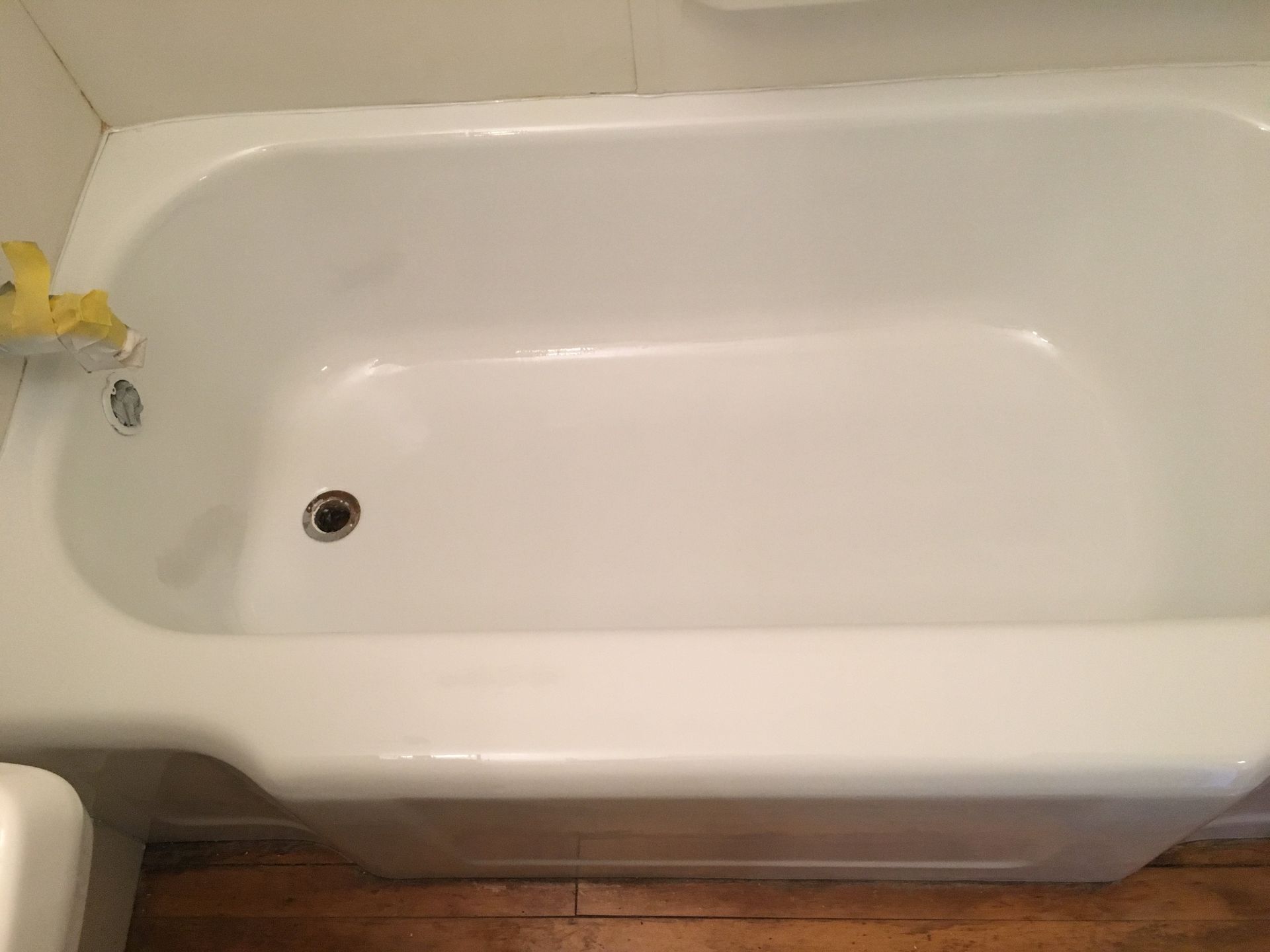 A white bathtub is sitting in a bathroom next to a sink.