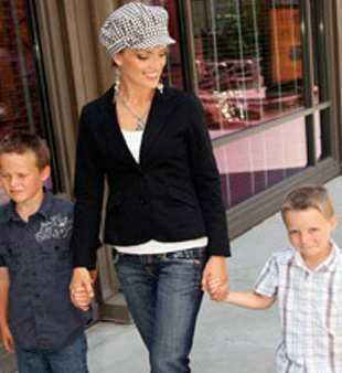 A woman walking with two boys