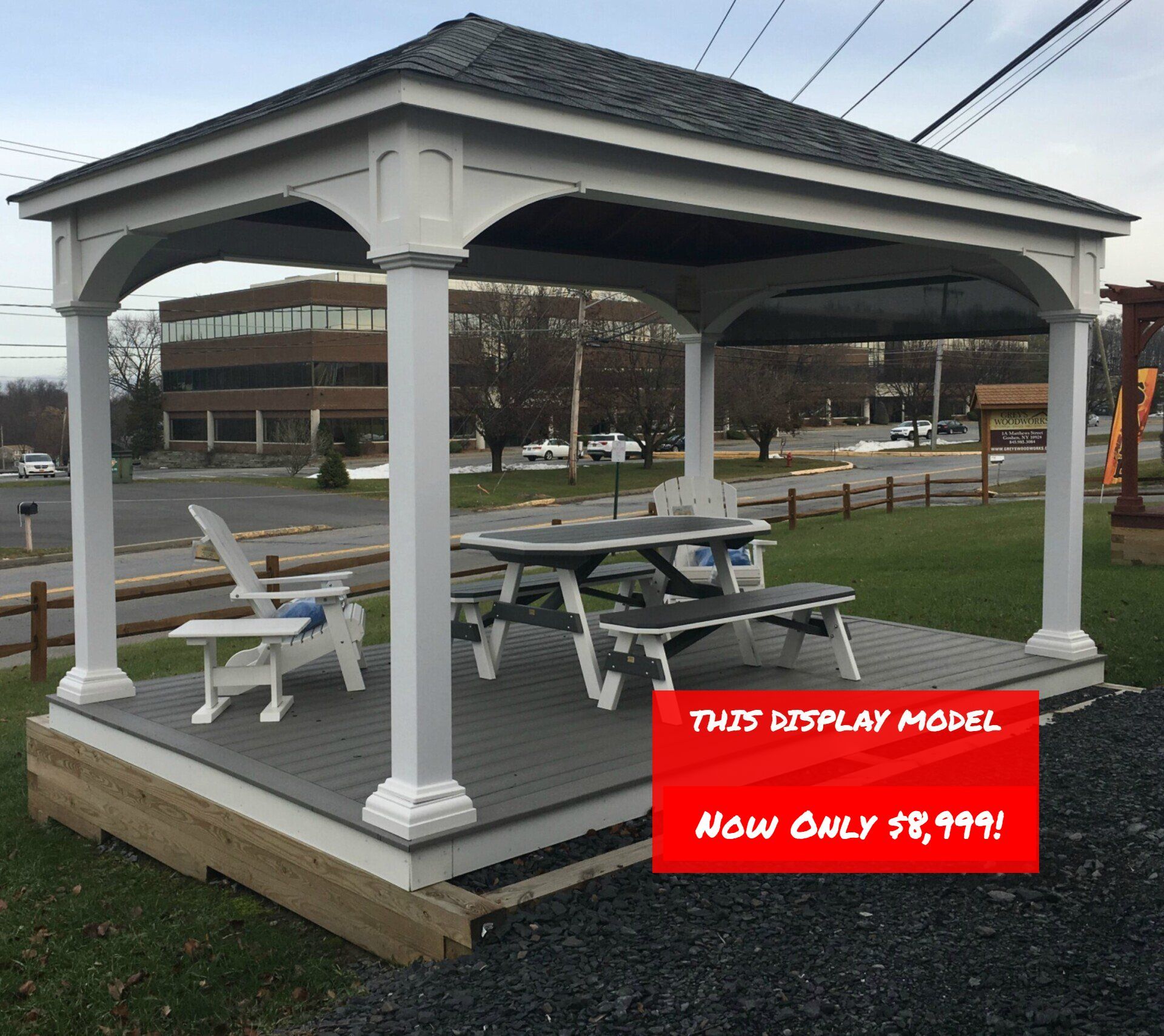 A gazebo with a picnic table and chairs underneath it