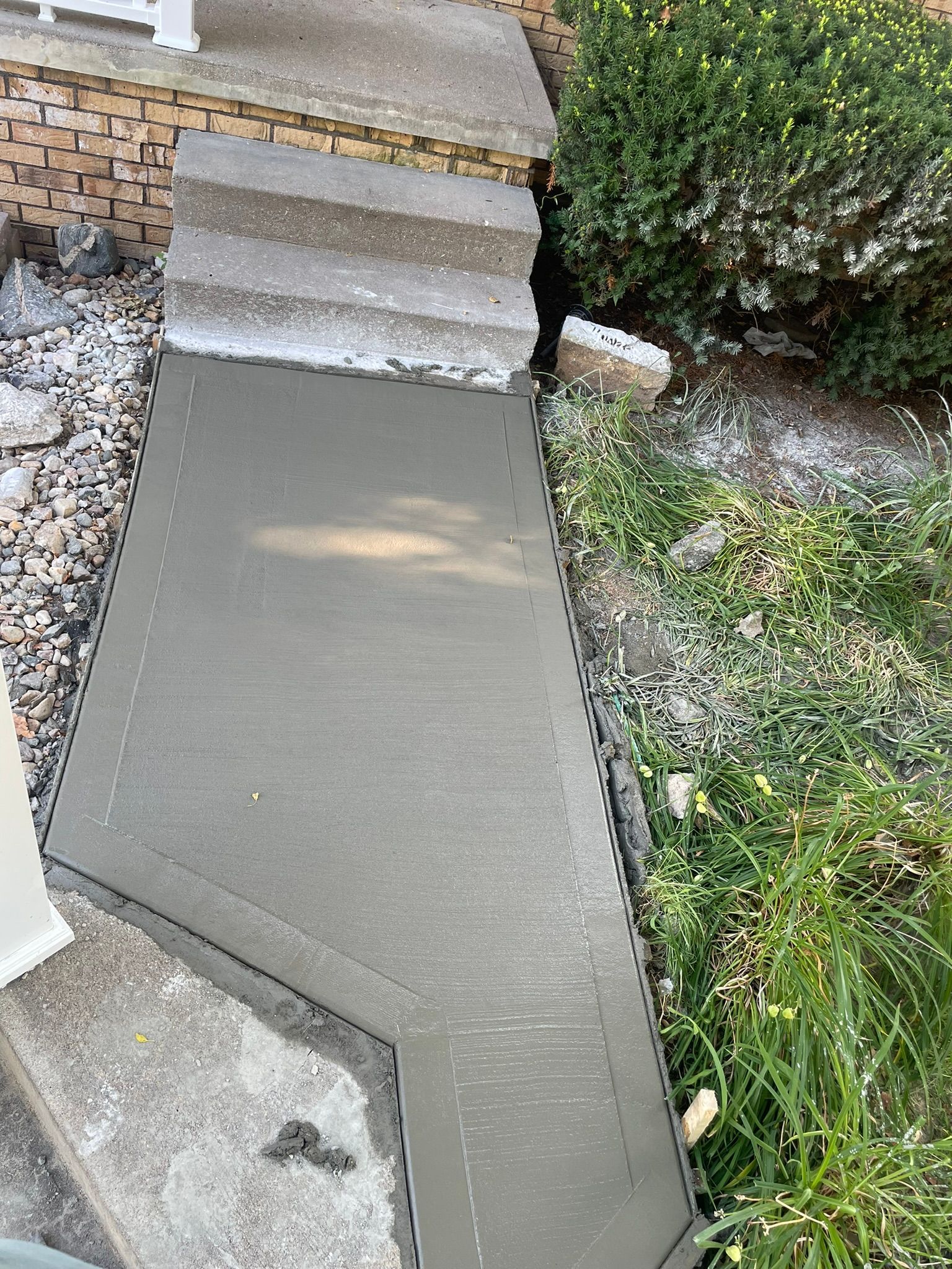 A concrete walkway is being built next to a set of stairs.