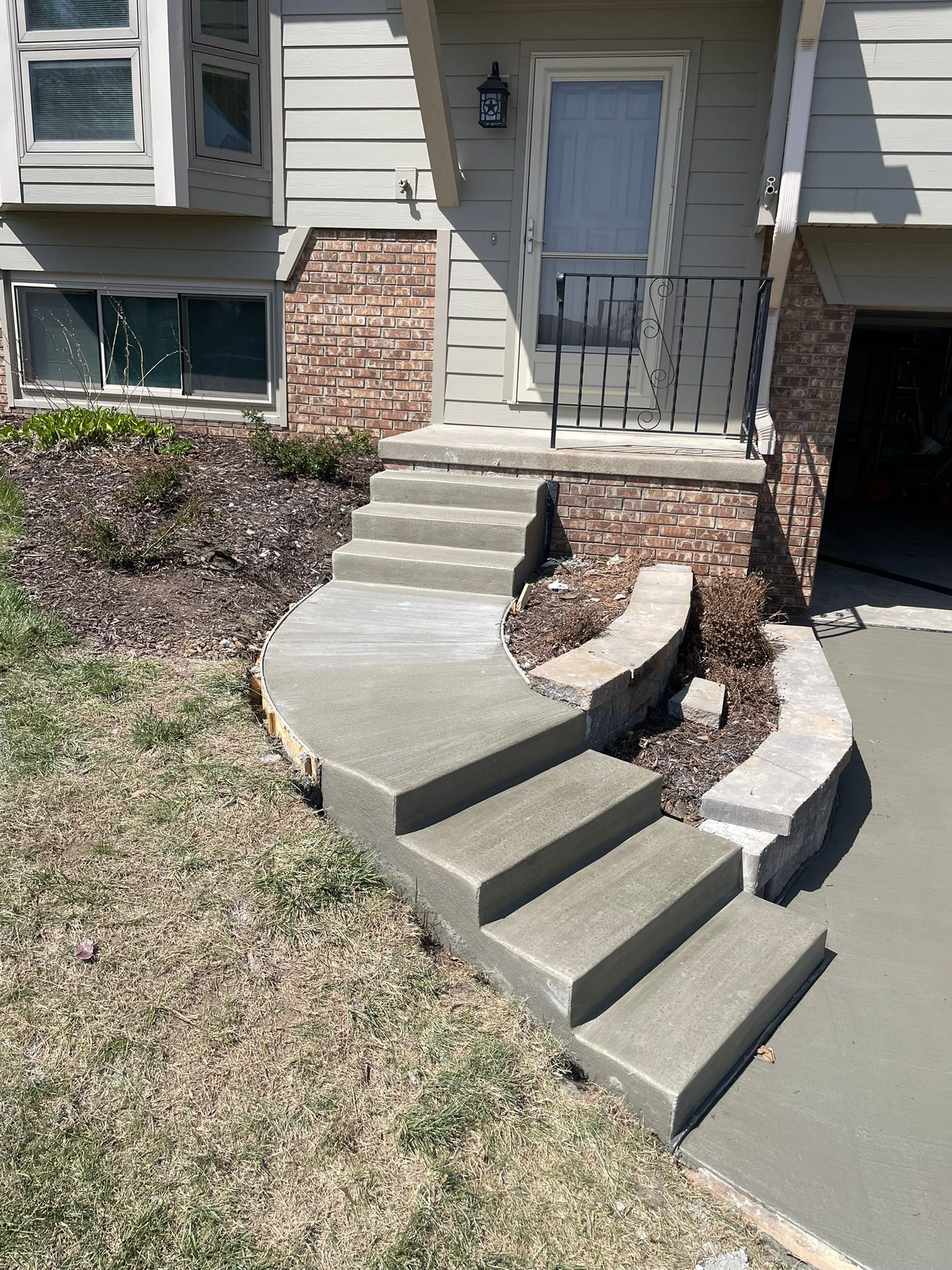 A set of concrete stairs leading up to a house.