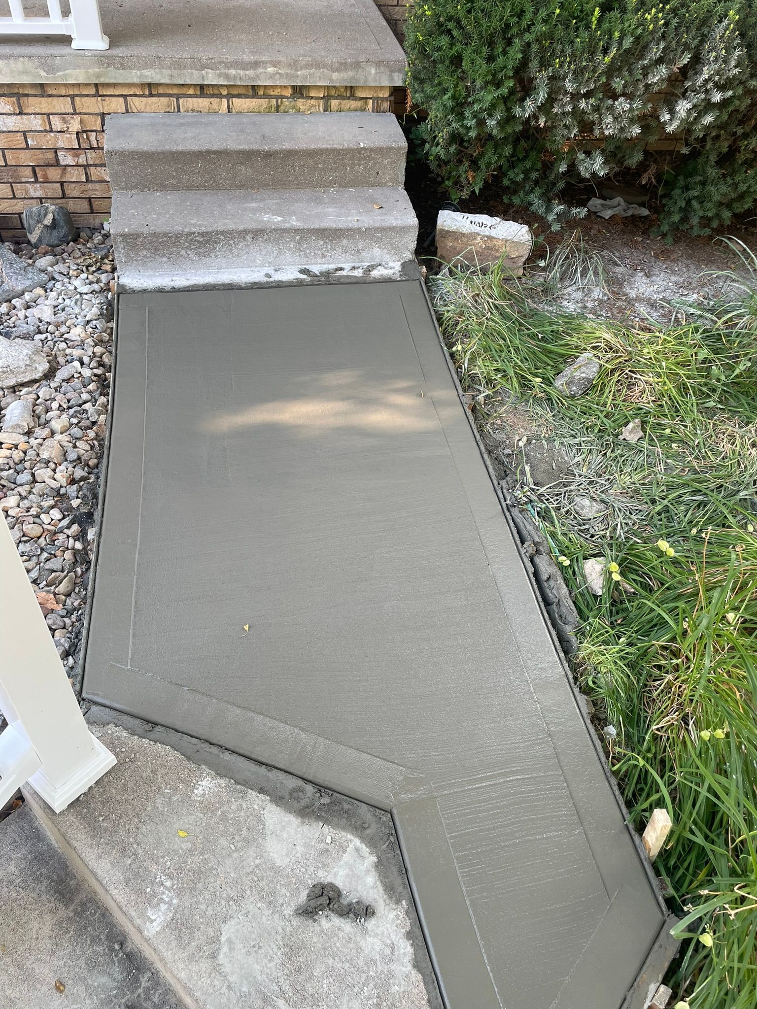A concrete walkway is being built next to a set of stairs.