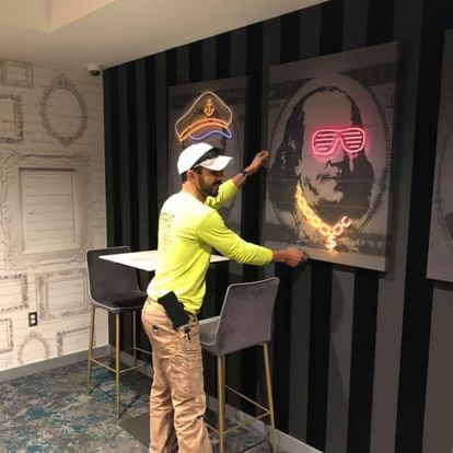 A man is standing in front of a painting of franklin d. roosevelt.