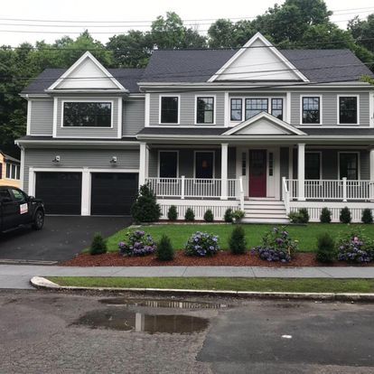 A large house with a car parked in front of it.
