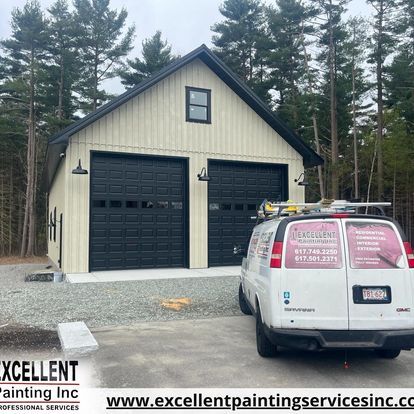 A white van is parked in front of a garage.