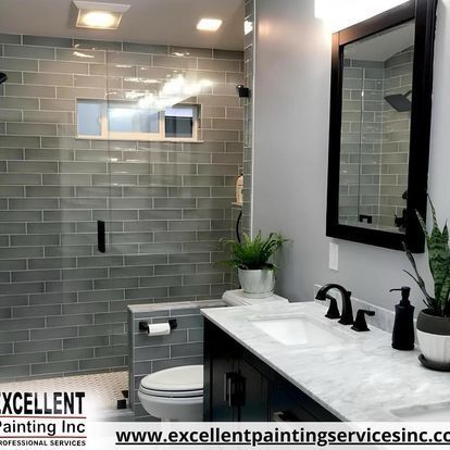 A bathroom with a sink, toilet, shower and mirror.