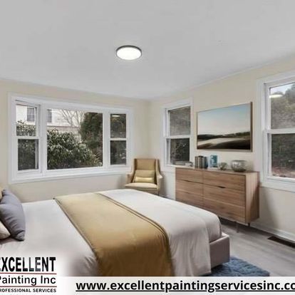 A bedroom with a bed, dresser, chair and lots of windows.