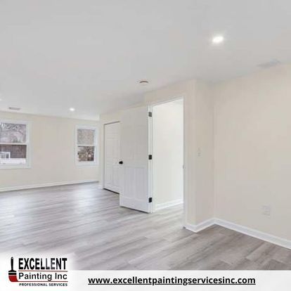 An empty room with white walls and a wooden floor.