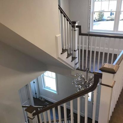 A view of a staircase from the second floor of a house.