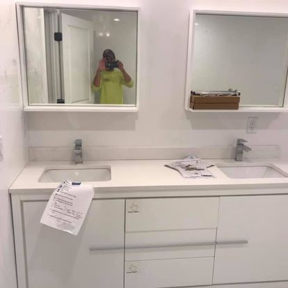 A bathroom with two sinks and two mirrors.