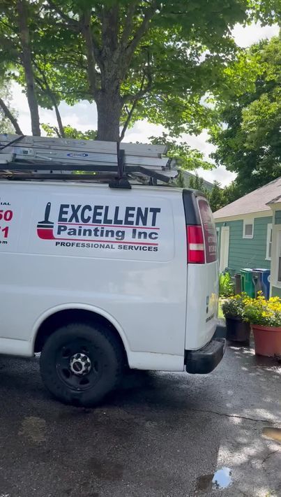 A white van is parked in front of a house.