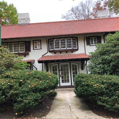 A large white house with a red tile roof