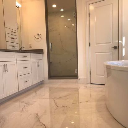 A bathroom with a tub, sink, and shower.