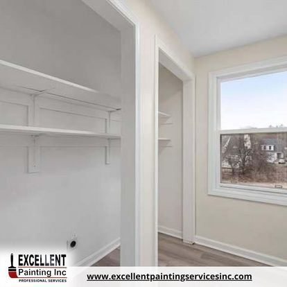 A closet with shelves and a window in a house.