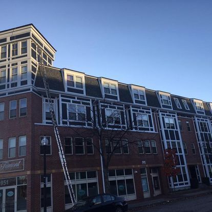 A large brick building with a car parked in front of it.