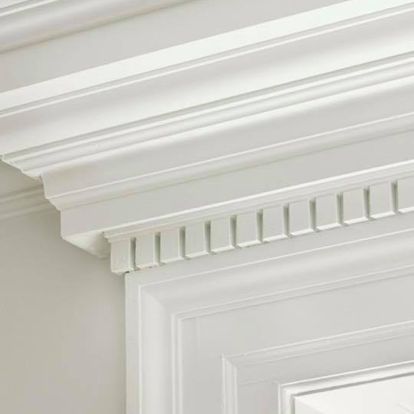 A close up of a white molding on a door.
