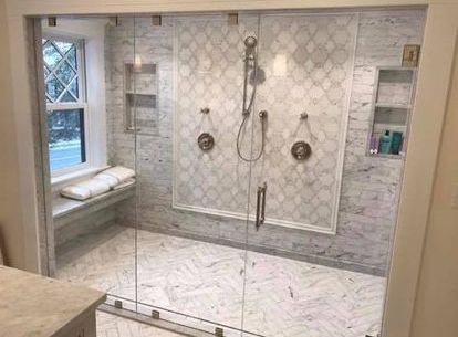A bathroom with a walk in shower and a window.
