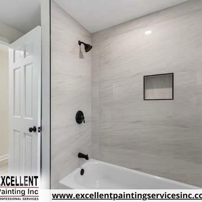 A bathroom with a bathtub and a shower.