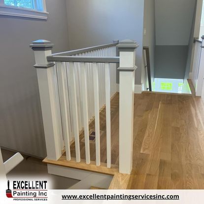 A staircase with a white railing and a wooden floor.