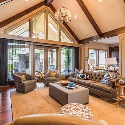 A living room filled with furniture and a vaulted ceiling.