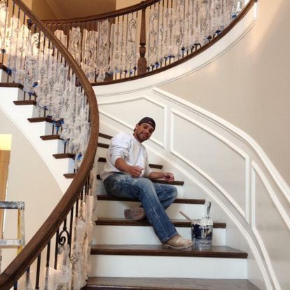 A man is sitting on the steps of a curved staircase