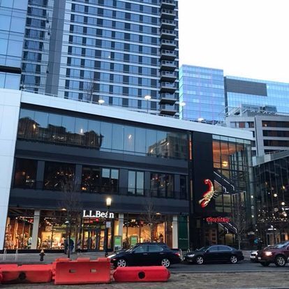 A building with a lot of windows and cars parked in front of it