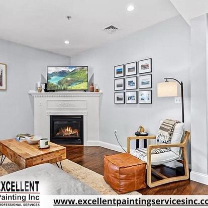 A living room with a fireplace, chair, coffee table and television.
