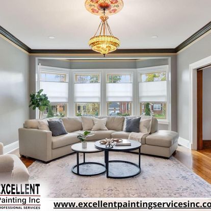 A living room with a couch, two coffee tables, and a chandelier.