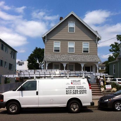 A white van is parked in front of a house
