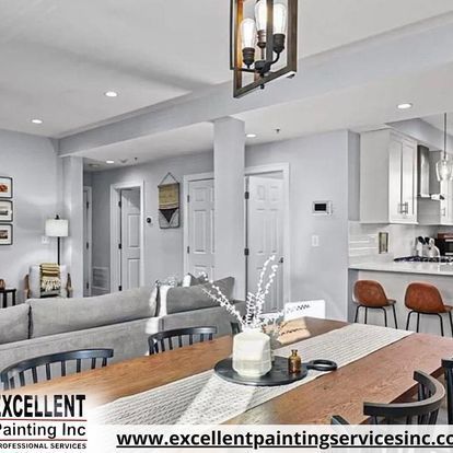 A living room with a dining table and chairs and a couch.