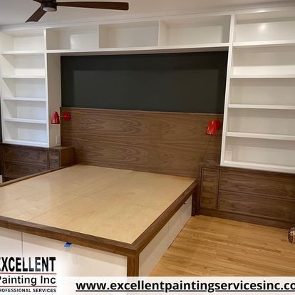 A bedroom with a bed, shelves and a ceiling fan.