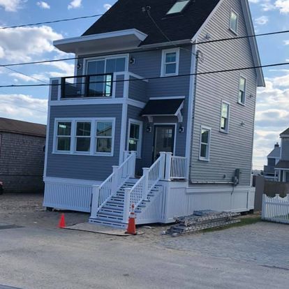 A large house with stairs leading up to the front door