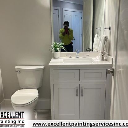 A bathroom with a toilet, sink, and mirror.