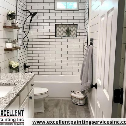A bathroom with white brick walls, a toilet, sink and bathtub.